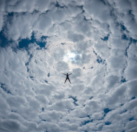 Person Lying High in Sky Viewed from Below