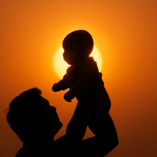 Baby Boy Silhouetted Against Sunrise Halo