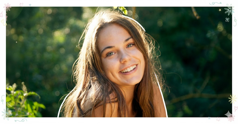 Girl standing outdoors with doodled floral border